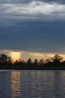 Northern German Water Scenery Drucke: Sunset over the river with dramatic clouds