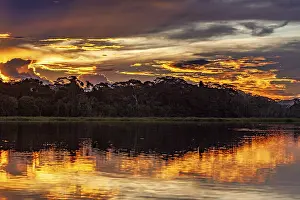 Dramatic Sky Reflections Drucke: Sunset over a river with dramatic sky and intense reflections
