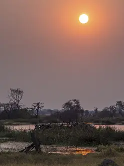 Okavango Delta Sunset Drucke: Sunset, river, Okavango Delta, Botswana