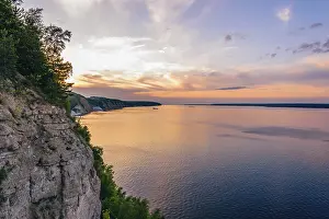 Erosion Landscape Photography Drucke: Sunset on river with reflected sky. Vew from cliff
