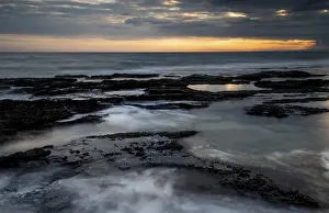 Uninhabited Coastal Region Drucke: Sunset on a rocky coast with dramatic cloudy sky