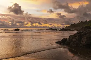 South American Coastal Scenery Drucke: Sunset on sandy beach, lava rocks