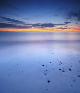 Evening Atmosphere Coastal Scene Drucke: Sunset at the sandy beach with pebbles