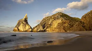 Evening Light Atmosphere Photo Drucke: Sunset on sandy beach with rocks