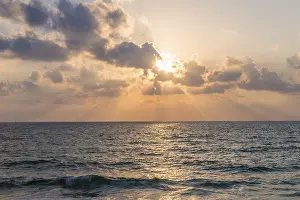 Deserted Evening Sea View Drucke: Sunset over the sea, clouds with sunrays