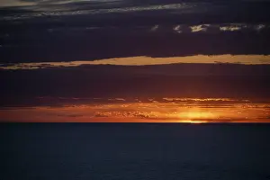 Deserted Beach Mallorca Drucke: Sunset over the sea, with dramatic clouds