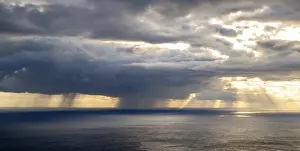 Madeira Sunset Drucke: Sunset, sun rays over sea, dark rain cloud