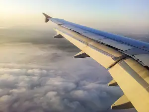 Atmospheric Evening Light Photos Drucke: Sunset view in flight from airplane window