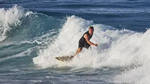 Karpathos Beach Scene Drucke: Surfer navigating through foamy waves in the ocean