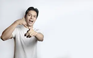 White Background Portrait Photo Drucke: Surprised man gesturing call me on white background