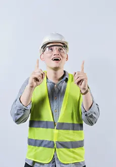 Young Architect Drucke: Surprised young architect pointing up
