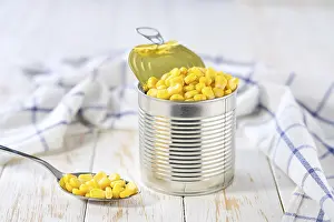 Canned Food Drucke: Sweet Canned Corn on a Light Kitchen Table