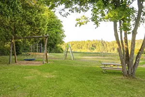 Agricultural Landscape Germany Drucke: A swing and a table in a green clearing with a view of fields