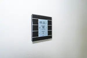 Minimalism In Interior Design Drucke: A switch with a display on a white wall