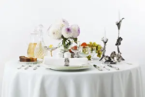 Plain Colored Background Drucke: Table with dishes and flowers on a white background