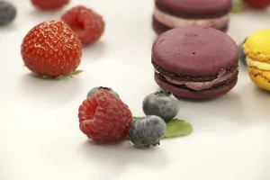 Pastel Colored Desserts Drucke: Table filled with array of macaroons and fruits visual appeal of the food