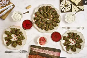 Stuffed Grape Leaves Drucke: A table is set with plates of stuffed grape leaves