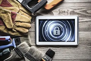 Security Concept Tablet Pc Drucke: Tablet pc with security concept on screen and industrial tools around