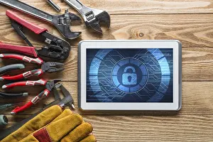 Safety Precautions In Industry Drucke: Tablet pc with security concept on screen and industrial tools around