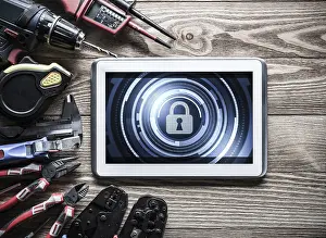 Handicraft Symbolism Drucke: Tablet pc with security concept on screen and industrial tools around