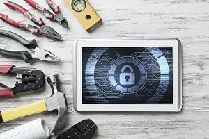 Security Concept Drucke: Tablet pc with security concept on screen and industrial tools around