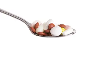 Healthcare Costs Drucke: Tablets on a spoon