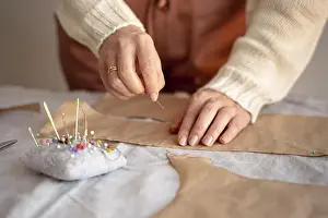 Handicraft Industry Worker Drucke: Tailor woman using needle thread sew