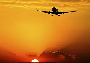 Deserted Air Traffic Scene Drucke: Takeoff of a passenger plane on the background of a sunset