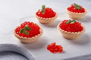 Studio Shot Of Breads Drucke: Tartlets with red caviar, on a light background