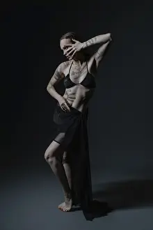 Airport Runway Style Drucke: A tattooed model poses gracefully in a dark setting