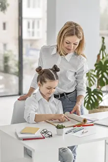 Educational Institution Training Drucke: Teacher helping her student learn