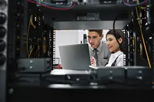 Healthcare Technology Drucke: Team of technicians working together on servers at the data centre