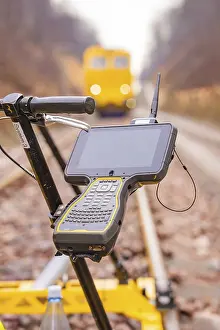 Southern Germany Train Photography Drucke: A technical device with a screen on a rail surveyor in the blur of the background