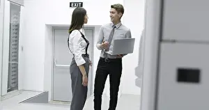 Server Room Technician Drucke: Technicians using laptop while analyzing server in server room