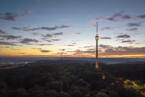 Radio Communication Mast Europe Drucke: Television tower at dusk over forest and under dramatic sky
