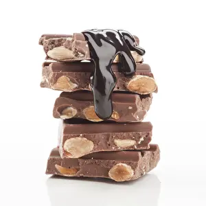 Food Photography Desserts Drucke: A tempting stack of chocolate bars filled with almonds