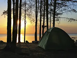 Sunset Landscape Photography Drucke: Tent in the forest on sunset background