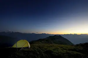 Austrian Mountain Landscape Drucke: Tent in front of a mountain range in the last daylight