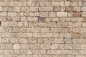 Uninhabited Stone Walls Drucke: Texture of old brown limestone wall as background