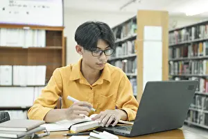 Education System Drucke: Thoughtful Young Student Preparing for Class