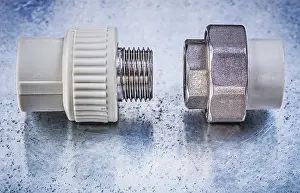 Construction Equipment Drucke: Threaded pipe connectors on metallic background construction concept