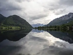 Stormy Atmosphere In Europe Drucke: Thunderclouds are reflected in the lake
