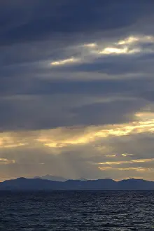 Backlit Cloud Photography Drucke: Thunderclouds at sunset on the beach