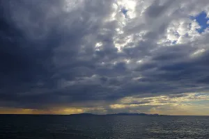 Tuscany Sunset Drucke: Thunderclouds at sunset on the beach