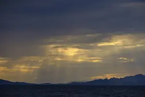 Evening Light In Southern Europe Drucke: Thunderclouds at sunset on the beach
