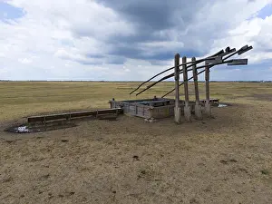 UNESCO Biosphere Reserve Drucke: Timber structure on a wide field under a cloudy sky