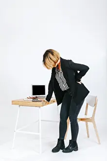 Tired Businesswoman Drucke: Tired office worker having spine problem