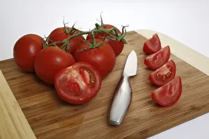 Studio Shot Of Tomatoes Drucke: Tomatoes on the vine, sliced