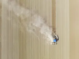Agricultural Crop Harvesting Drucke: Tractor at field work. Aerial view