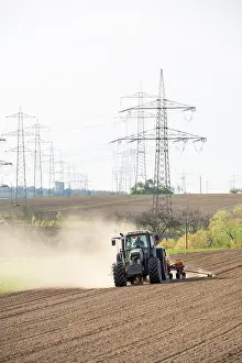 Agricultural Machine Europe Drucke: Tractor with seed drill in the field in spring